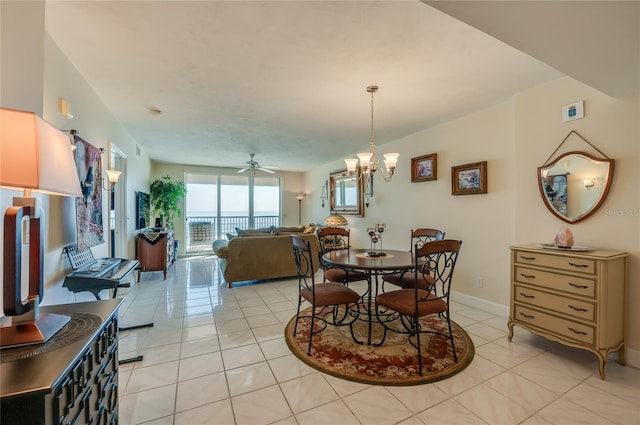 dining room featuring ceiling fan with notable chandelier and light tile patterned flooring