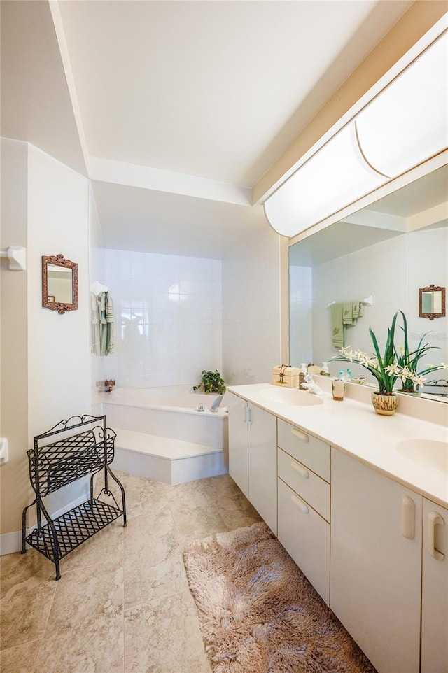 bathroom featuring vanity and a bath