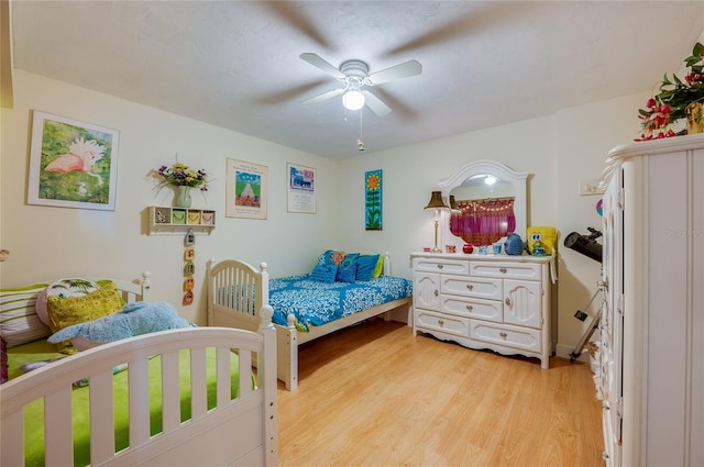 bedroom with ceiling fan and light hardwood / wood-style flooring