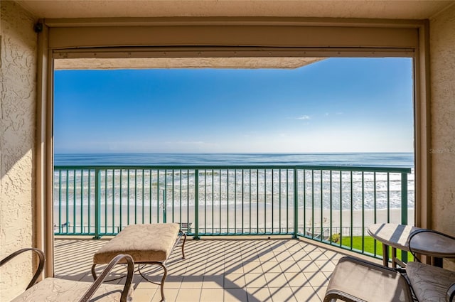 balcony with a beach view and a water view