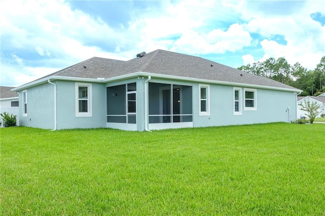 back of house with a sunroom and a yard