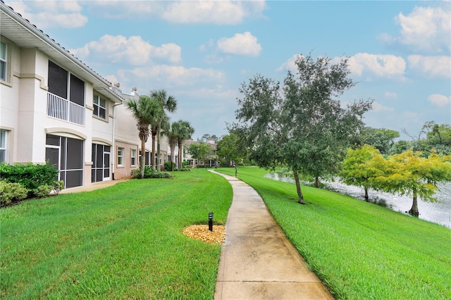 view of community featuring a yard and a water view