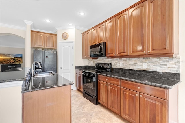 kitchen with dark stone counters, decorative backsplash, black appliances, and sink