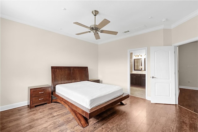 bedroom with ornamental molding, dark wood-type flooring, ceiling fan, and ensuite bathroom