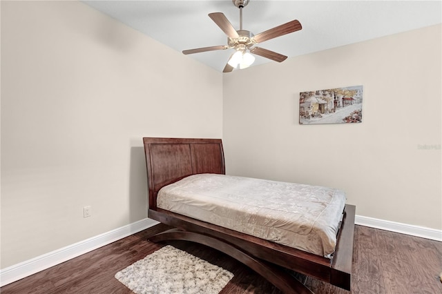 bedroom with ceiling fan and dark wood-type flooring