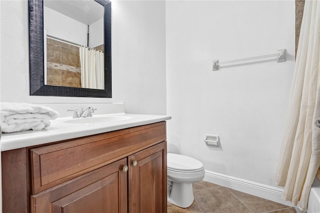 bathroom with vanity, tile patterned flooring, and toilet