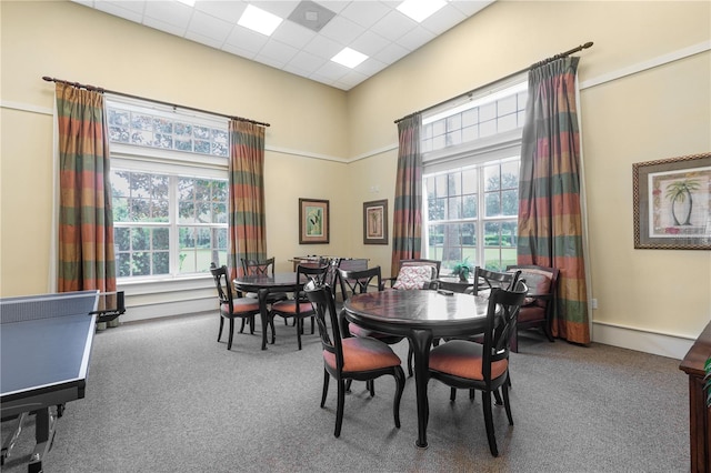 dining room featuring carpet floors, a paneled ceiling, and plenty of natural light