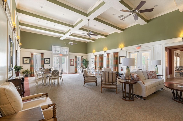 living room with ceiling fan, carpet flooring, french doors, and a high ceiling