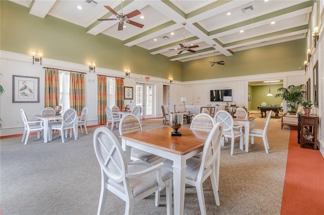 carpeted dining area with beamed ceiling, billiards, crown molding, a high ceiling, and ceiling fan