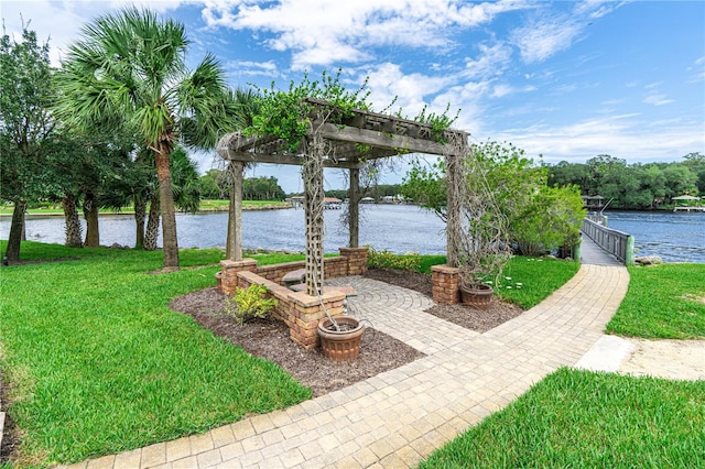 view of yard with a pergola and a water view