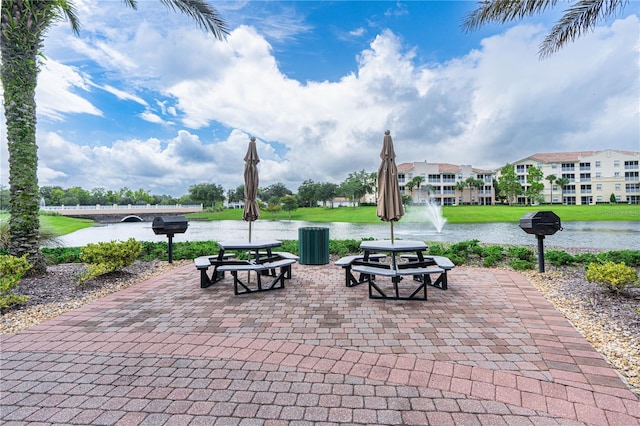 view of community with a yard and a water view