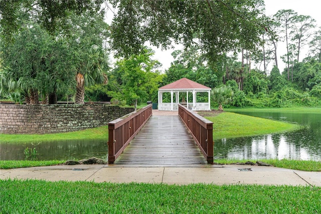 view of home's community with a gazebo, a water view, and a yard