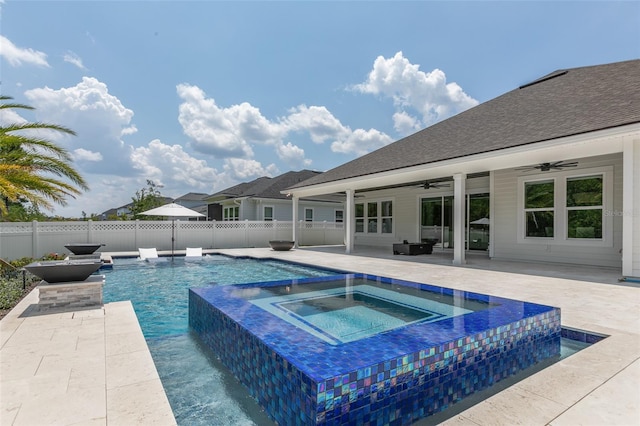 view of pool featuring a patio area, pool water feature, ceiling fan, and an in ground hot tub