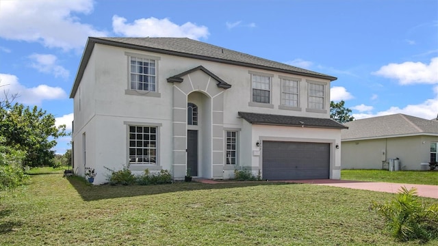 front of property featuring a front yard and a garage