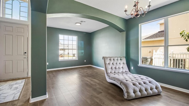 entrance foyer featuring an inviting chandelier and dark wood-type flooring