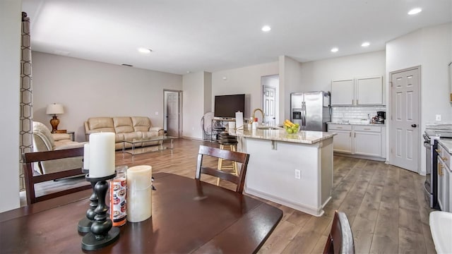 dining space with sink and light hardwood / wood-style flooring