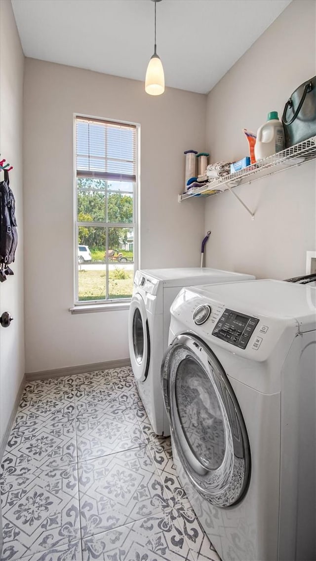 washroom featuring light tile patterned floors and washer and dryer