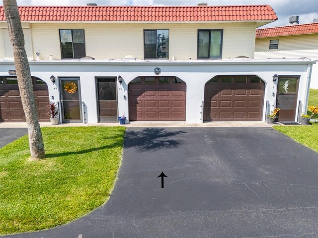 view of front of house with a front yard and a garage