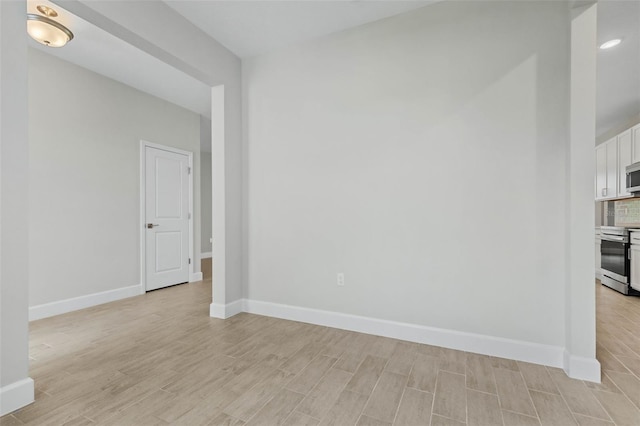 empty room with light hardwood / wood-style flooring