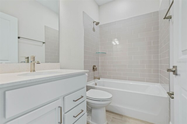 full bathroom with tiled shower / bath, vanity, toilet, and hardwood / wood-style flooring