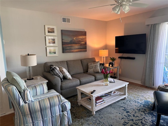 living room with ceiling fan and dark hardwood / wood-style floors