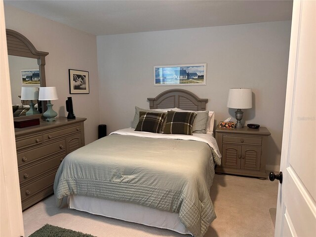 bedroom with light colored carpet