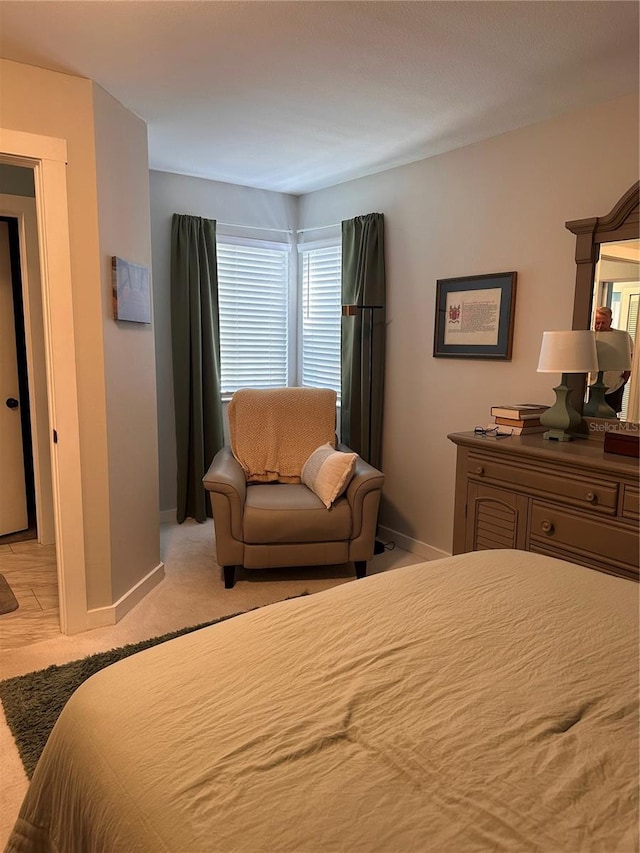 bedroom featuring light carpet