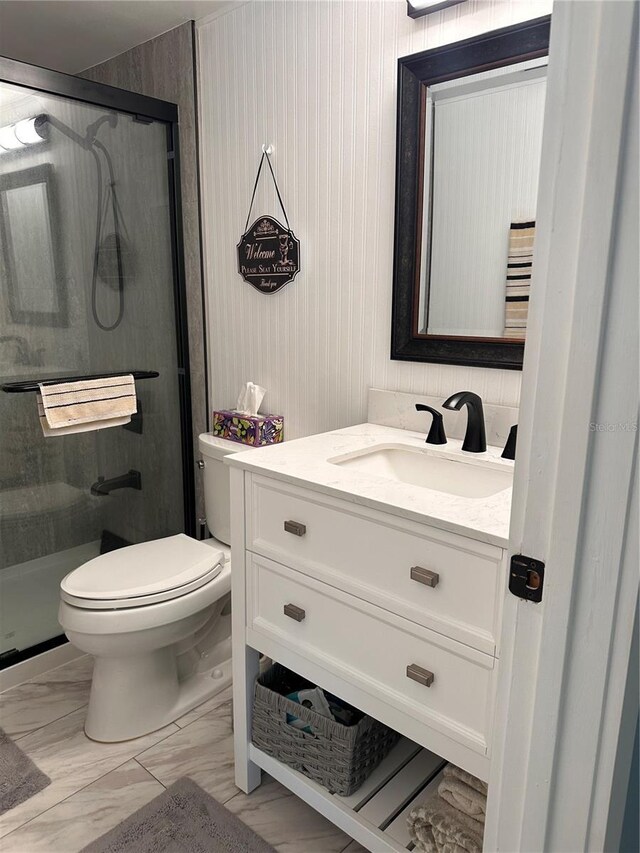 bathroom with walk in shower, vanity, and toilet