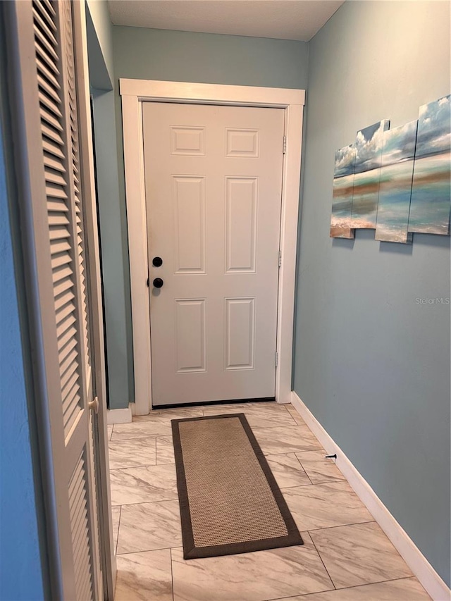 610 Ocean Marina Dr Unit 106, Flagler Beach, FL 32136 - doorway featuring marble finish floor and baseboards