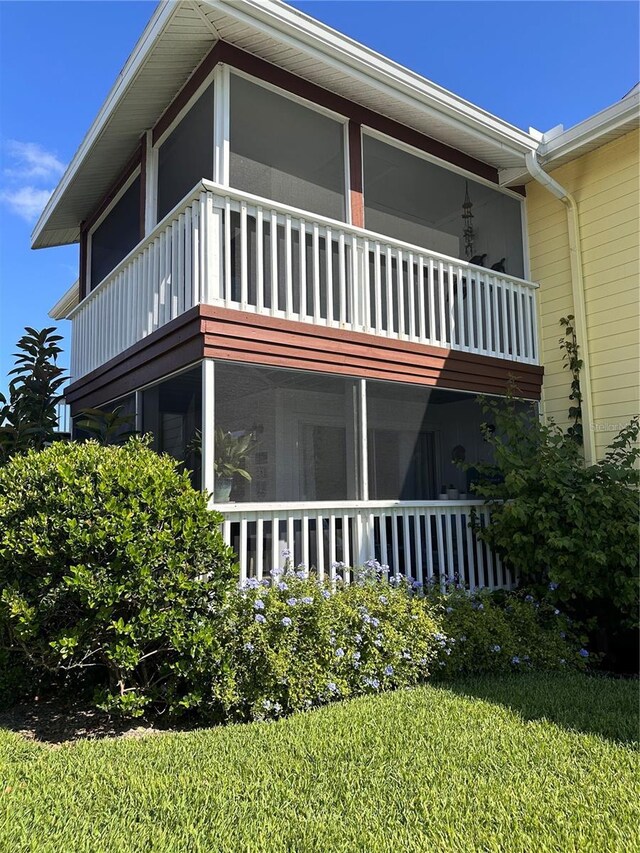 exterior space with a balcony and a yard