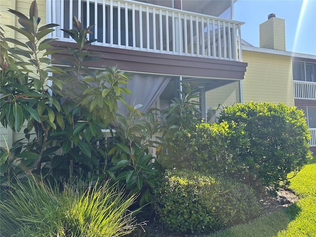 view of side of home featuring a balcony