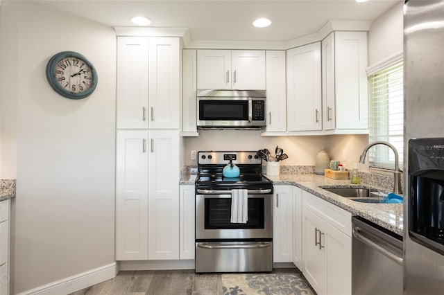 kitchen featuring white cabinetry, appliances with stainless steel finishes, and sink