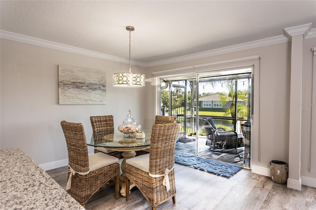 dining room featuring hardwood / wood-style floors and crown molding