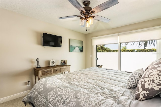 carpeted bedroom with ceiling fan, a textured ceiling, and access to exterior