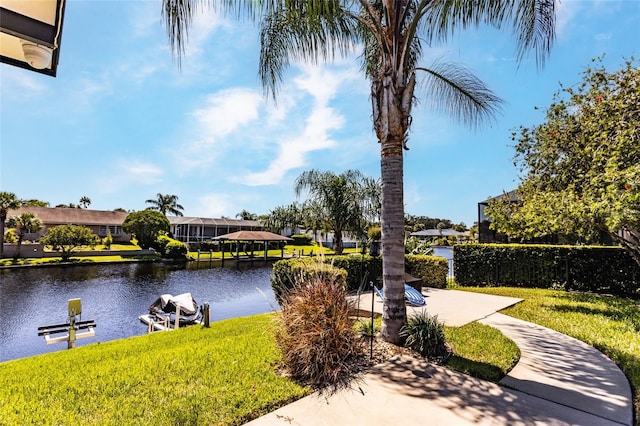 view of home's community featuring a yard and a water view