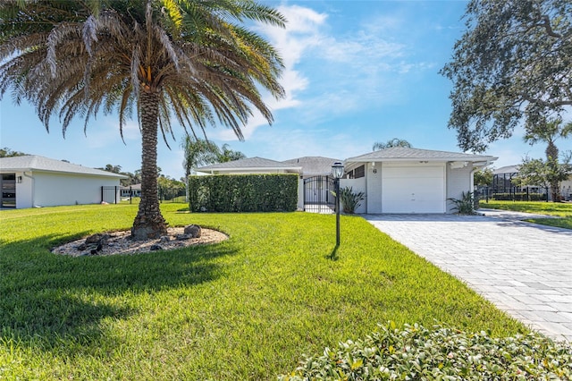 single story home featuring a garage and a front yard