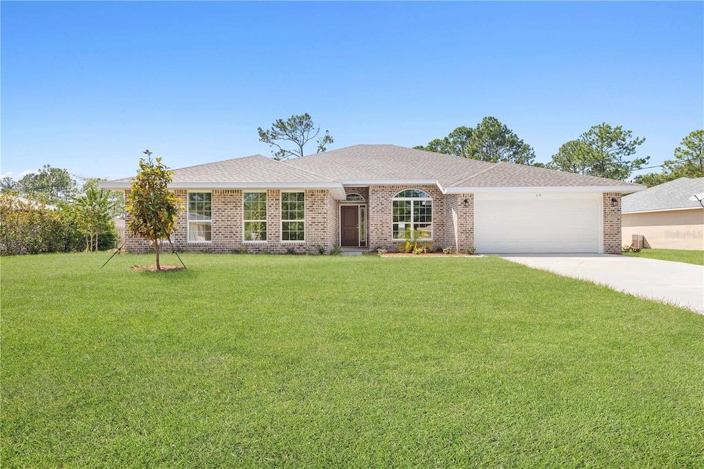 ranch-style house featuring a front yard and a garage