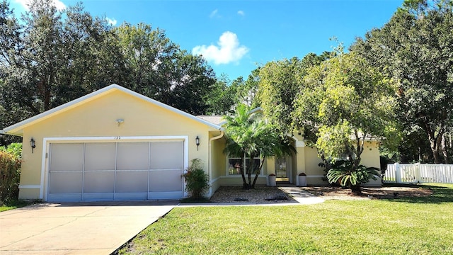 view of front of property featuring a front yard and a garage