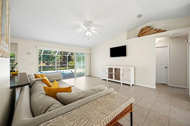 living room featuring lofted ceiling, light tile patterned flooring, a textured ceiling, and ceiling fan