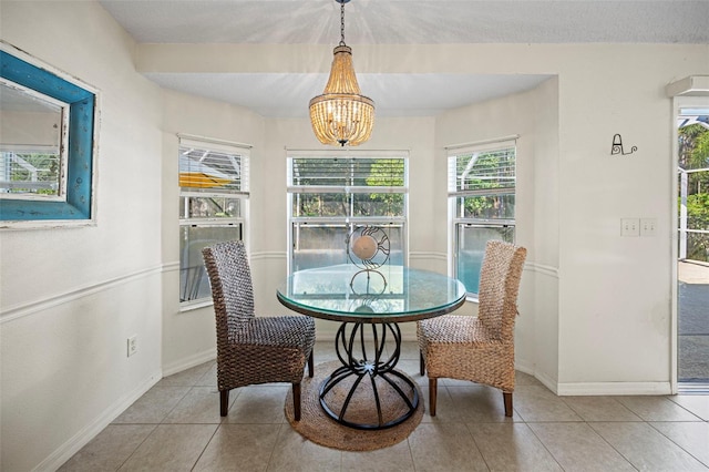 dining space featuring a chandelier and light tile patterned floors