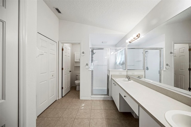 bathroom with toilet, a shower with shower door, vaulted ceiling, vanity, and a textured ceiling