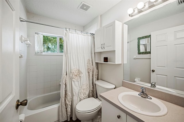 full bathroom featuring vanity, toilet, a textured ceiling, and shower / bath combo