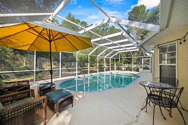 view of swimming pool featuring a patio and glass enclosure