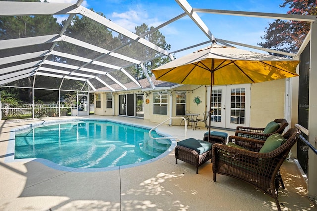 view of pool featuring french doors, a patio area, and a lanai