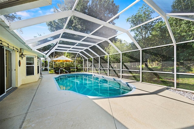 view of swimming pool featuring a patio area and a lanai