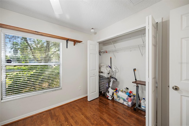 122 Lindsay Dr, Palm Coast, FL 32137 - bedroom with a closet, dark wood finished floors, a textured ceiling, and ceiling fan