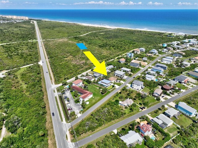 drone / aerial view featuring a water view and a beach view