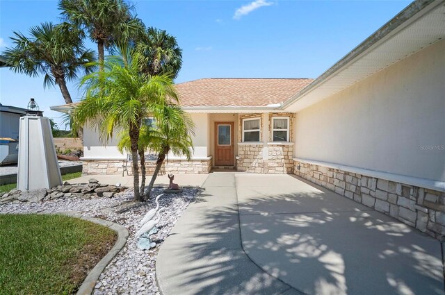 entrance to property featuring a patio