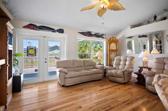 living room featuring french doors, lofted ceiling, light wood-type flooring, and ceiling fan