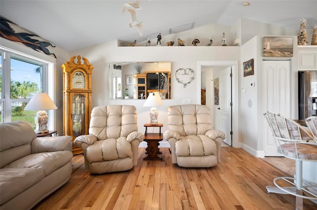 living room with light hardwood / wood-style flooring and lofted ceiling